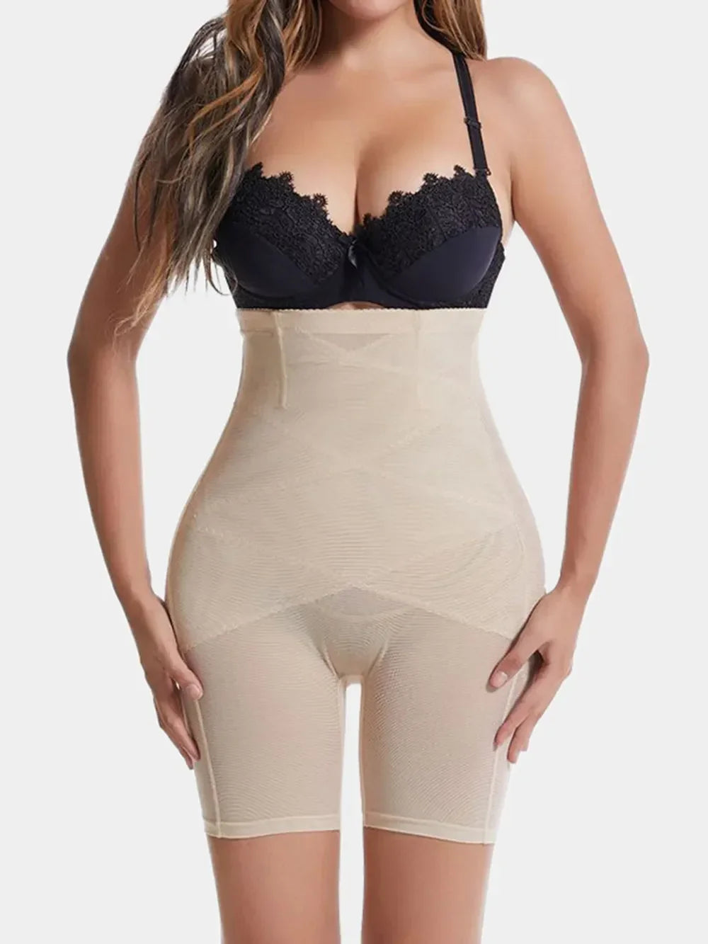 Woman wearing high-waisted beige body shaper shorts for slimming and support