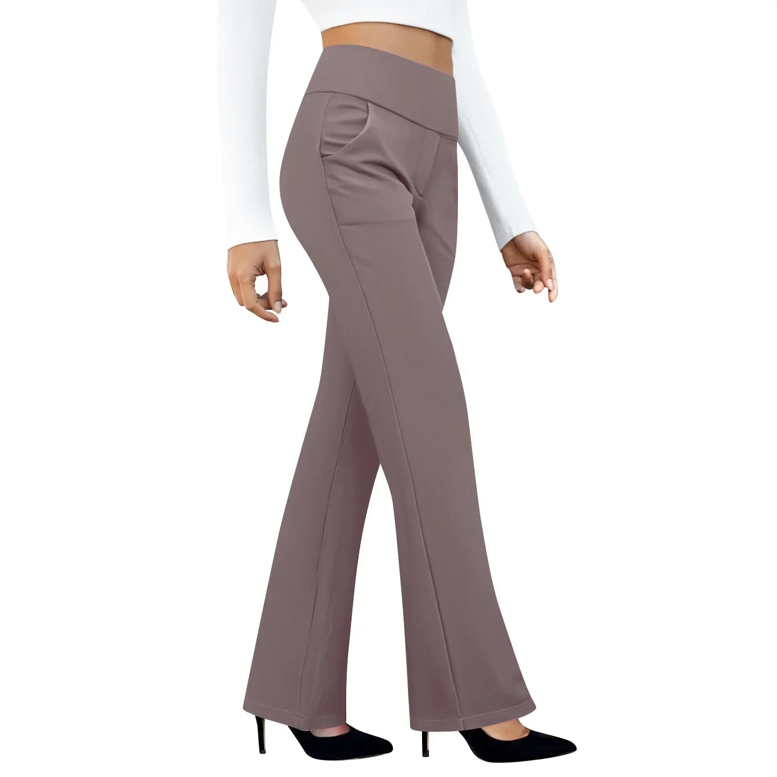 Woman wearing high-waisted taupe flare pants with pockets and black heels on white background