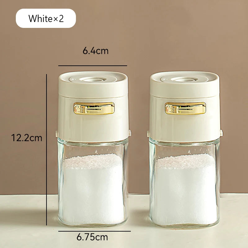 Set of two white kitchen storage jars with gold latches, clear glass bodies, and dimension labels