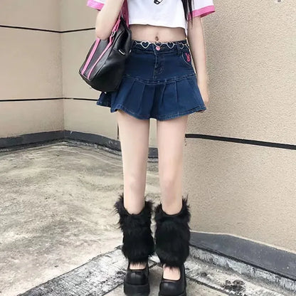 Woman wearing denim pleated mini skirt, cropped top, furry leg warmers, and platform shoes