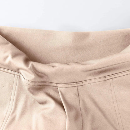 Close-up of beige high-waisted pants with soft stretch waistband and visible stitching