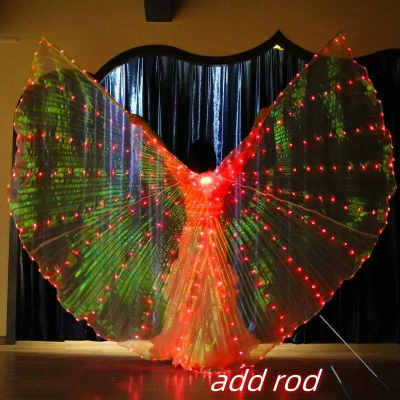 Person wearing large LED light up wings costume with red and green lights on stage