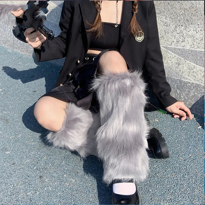 Person sitting outdoors wearing gray faux fur leg warmers, black skirt, and black jacket