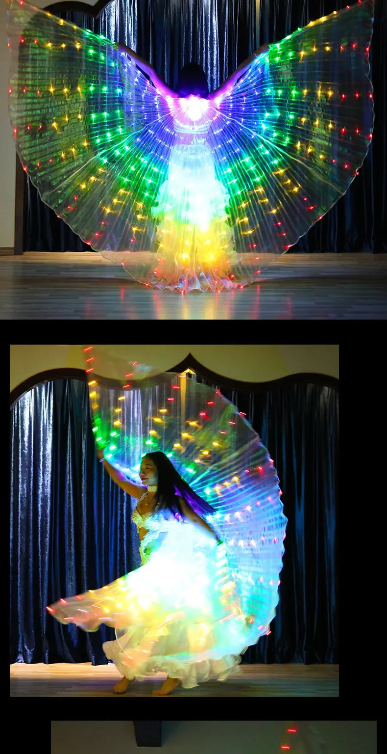 Woman dancing with large LED light-up rainbow wings on stage, colorful glowing costume
