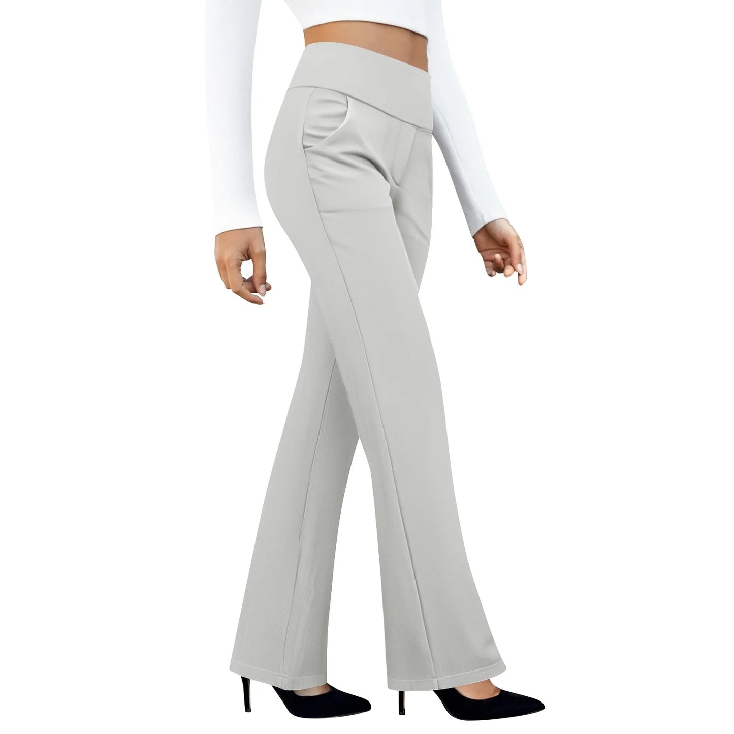 Woman wearing high waisted light gray flare pants with a white crop top and black heels