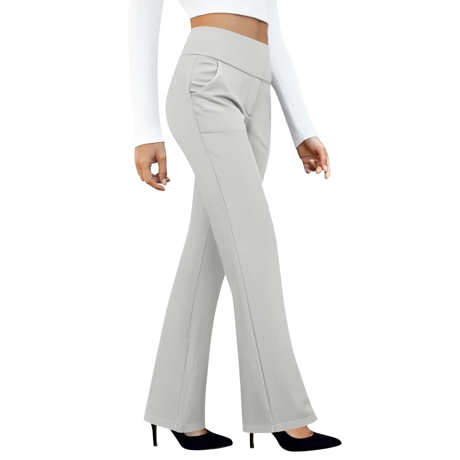 Woman wearing high waisted light gray flare pants with a white crop top and black heels