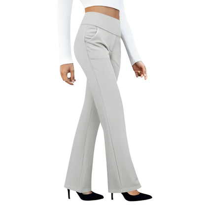 Woman wearing high waisted light gray flare pants with a white crop top and black heels