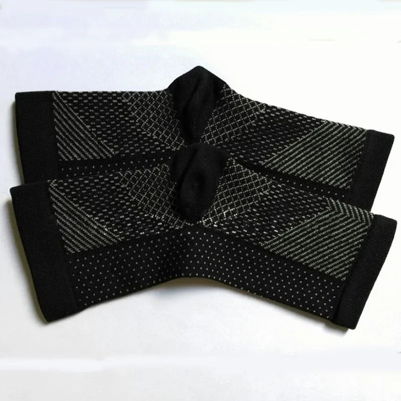 Pair of black compression ankle sleeves with grey patterns on white background