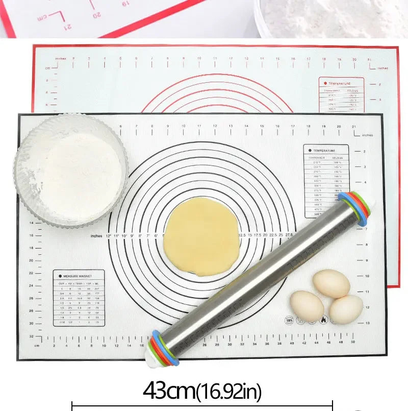 Non-stick silicone baking mat with measurement guides, rolling pin, dough, eggs, and flour