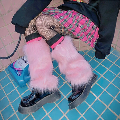 Person wearing pink faux fur leg warmers, plaid skirt, fishnet tights, and platform boots