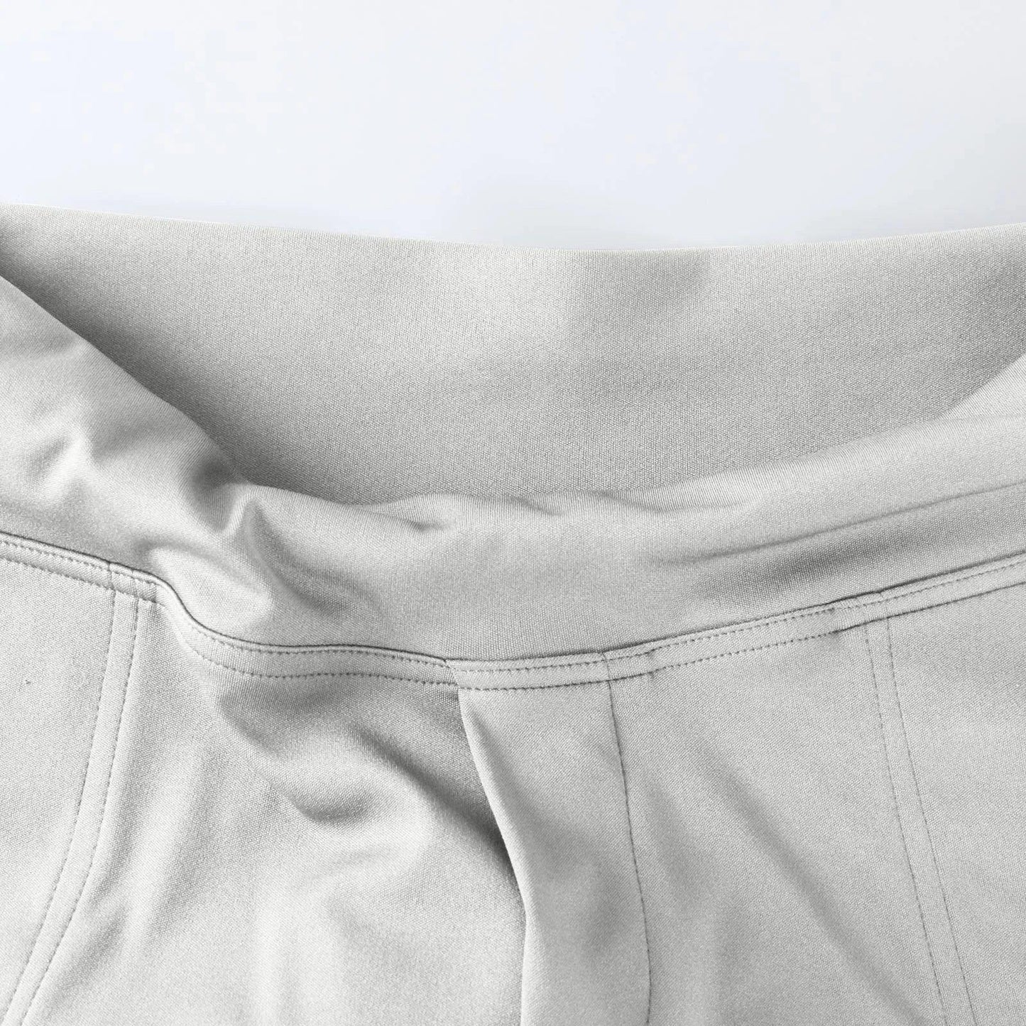 Close-up of light gray elastic waistband lounge pants with soft fabric and stitched seams