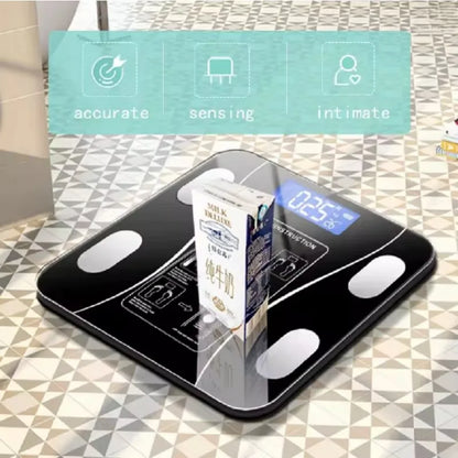 Digital bathroom scale with carton of milk on display, showing weight on LED screen.