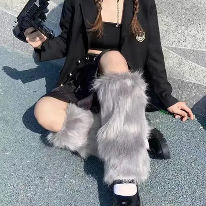 Woman in streetwear outfit with gray faux fur leg warmers and black mini skirt sitting outdoors