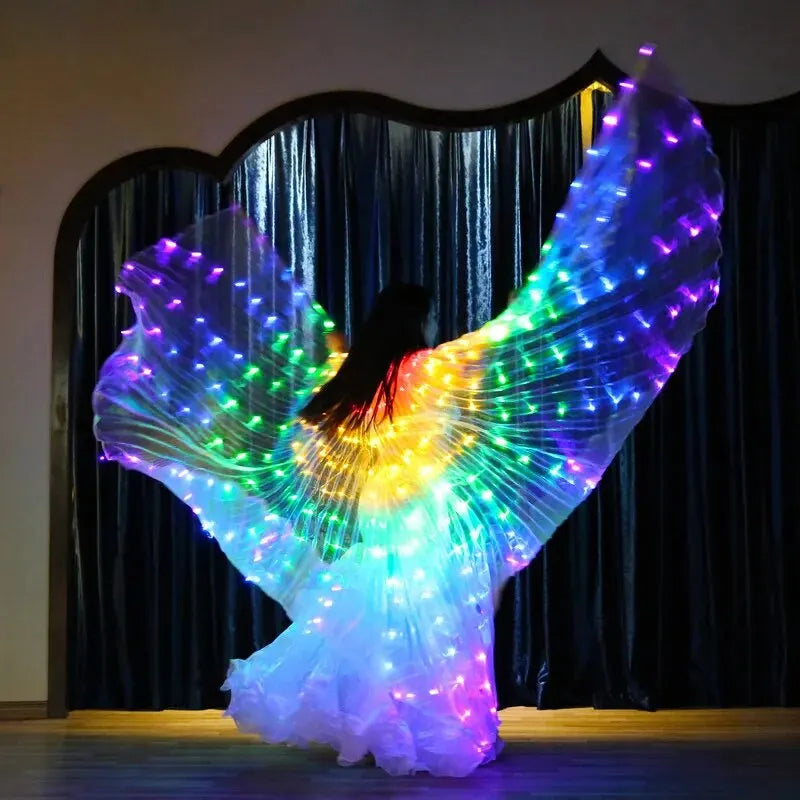 Person dancing in flowing LED light up wings with rainbow colors on stage