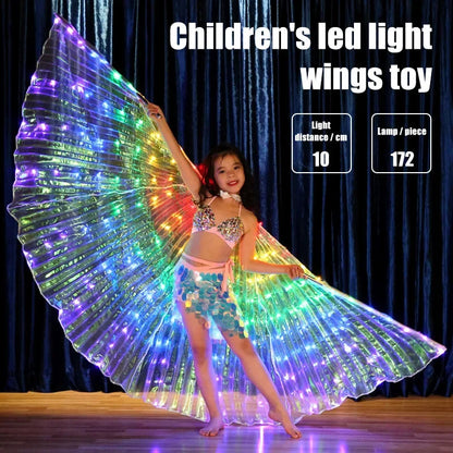 Smiling child wearing LED light up fairy wings toy and colorful costume on stage.