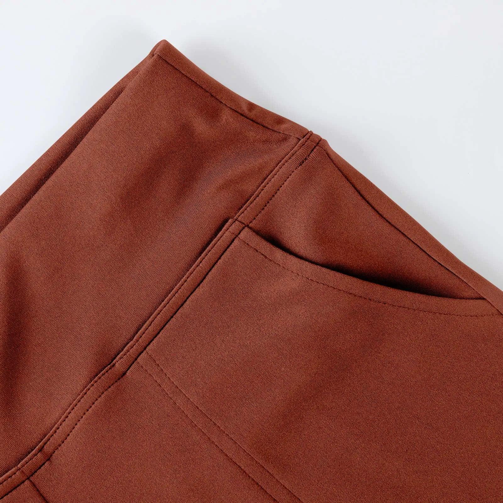 Close-up of brown pants pocket with visible stitching, modern lifestyle apparel detail