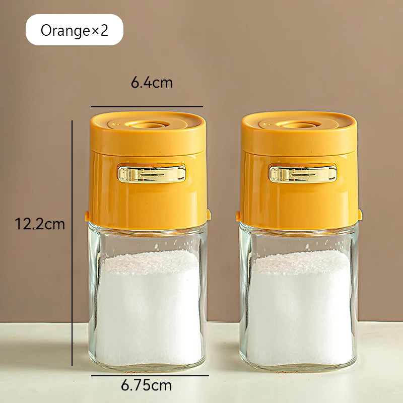 Set of two orange-lidded glass seasoning containers with labeled dimensions, kitchen storage jars