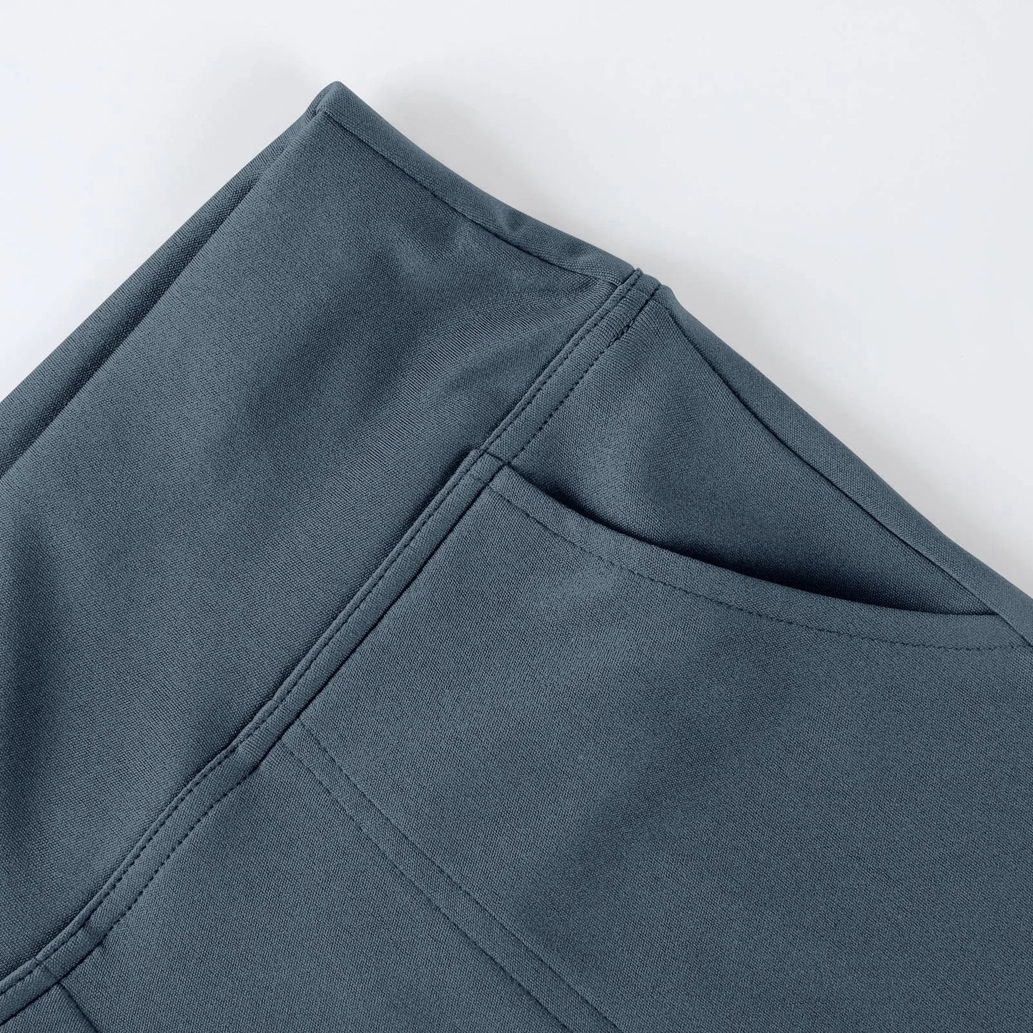 Close-up of grey athletic leggings with side pocket and smooth fabric texture