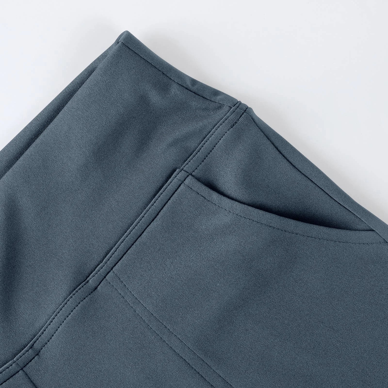 Close-up of grey athletic leggings with side pocket and smooth fabric texture