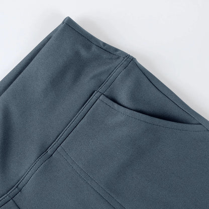 Close-up of grey athletic leggings with side pocket and smooth fabric texture