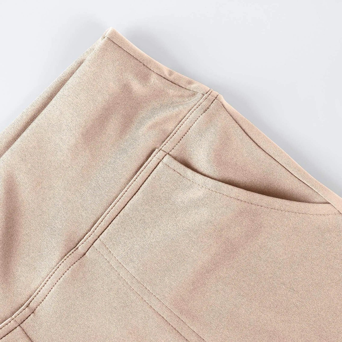 Close-up of beige pants pocket with visible stitching on smooth fabric