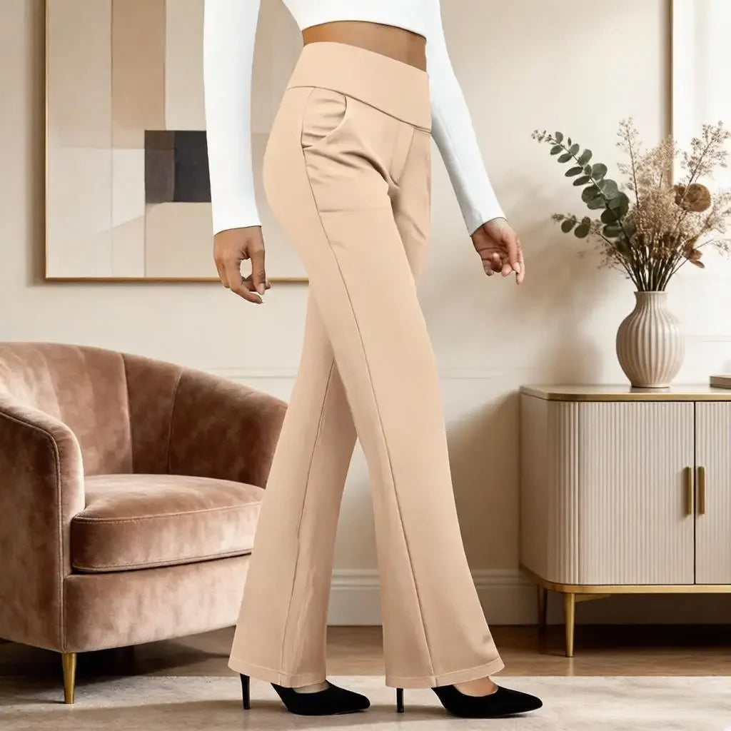 Woman wearing beige high-waisted flared pants and black heels in modern living room