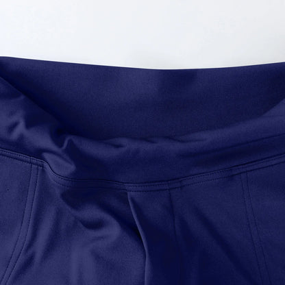Close-up of blue athletic leggings waistband with smooth fabric and detailed stitching
