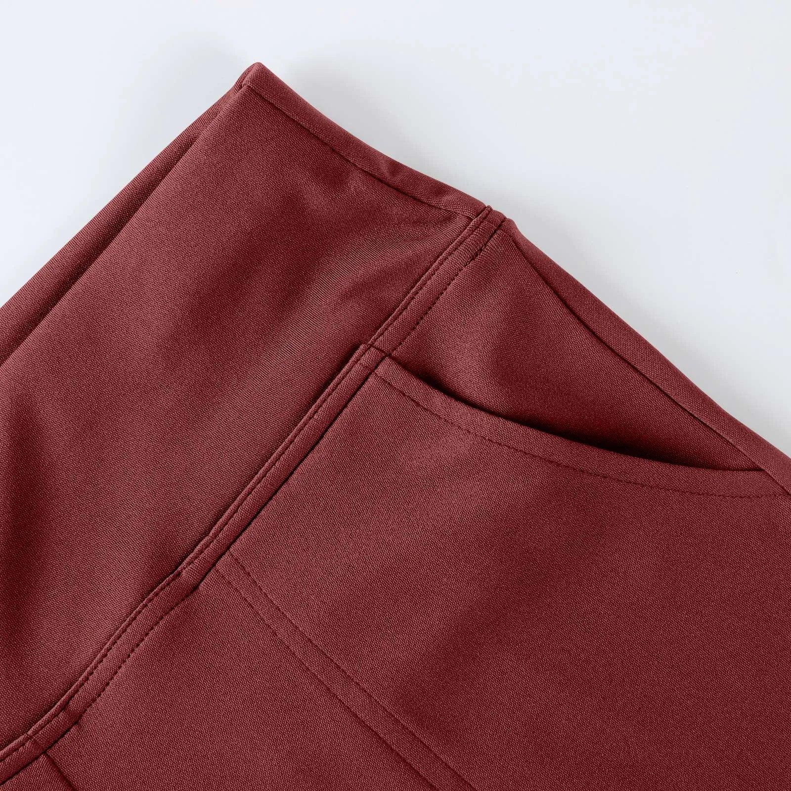 Close-up of maroon athletic leggings with pocket and stitched detail on white background