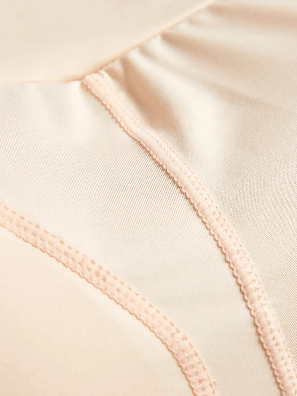 Close-up of beige seamless fabric underwear with soft stitching detail